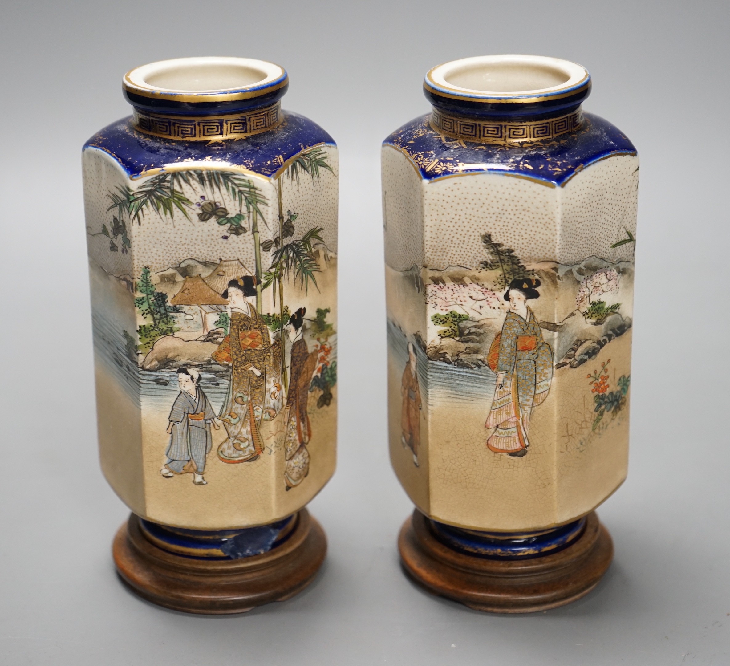 A pair of Japanese Satsuma pottery hexagonal vases, Meiji period, on stands 16cm